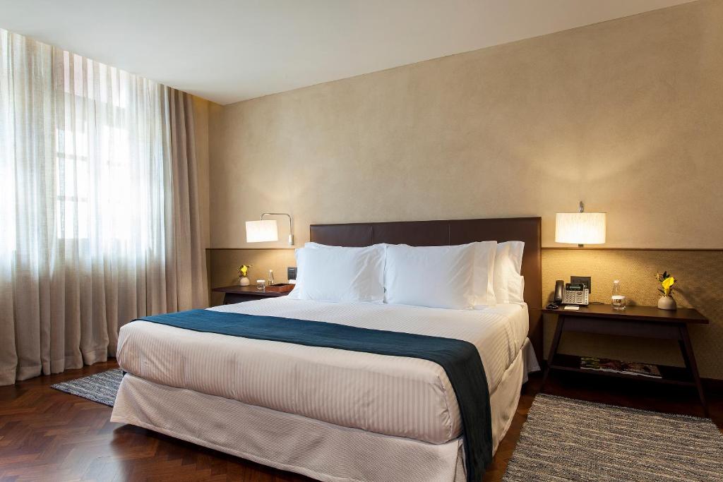 http://Lit%20king-size%20et%20tables%20de%20chevet%20dans%20une%20chambre%20lumineuse%20et%20épurée%20de%20l'hôtel%20Fasano%20Salvador.